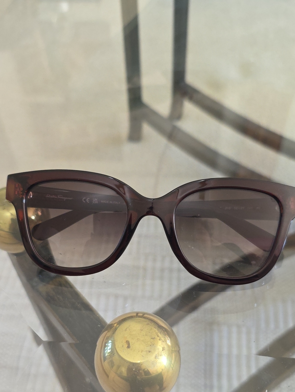 Salvatore Ferragamo SF1066S sunglasses feature a dark crystal brown frame